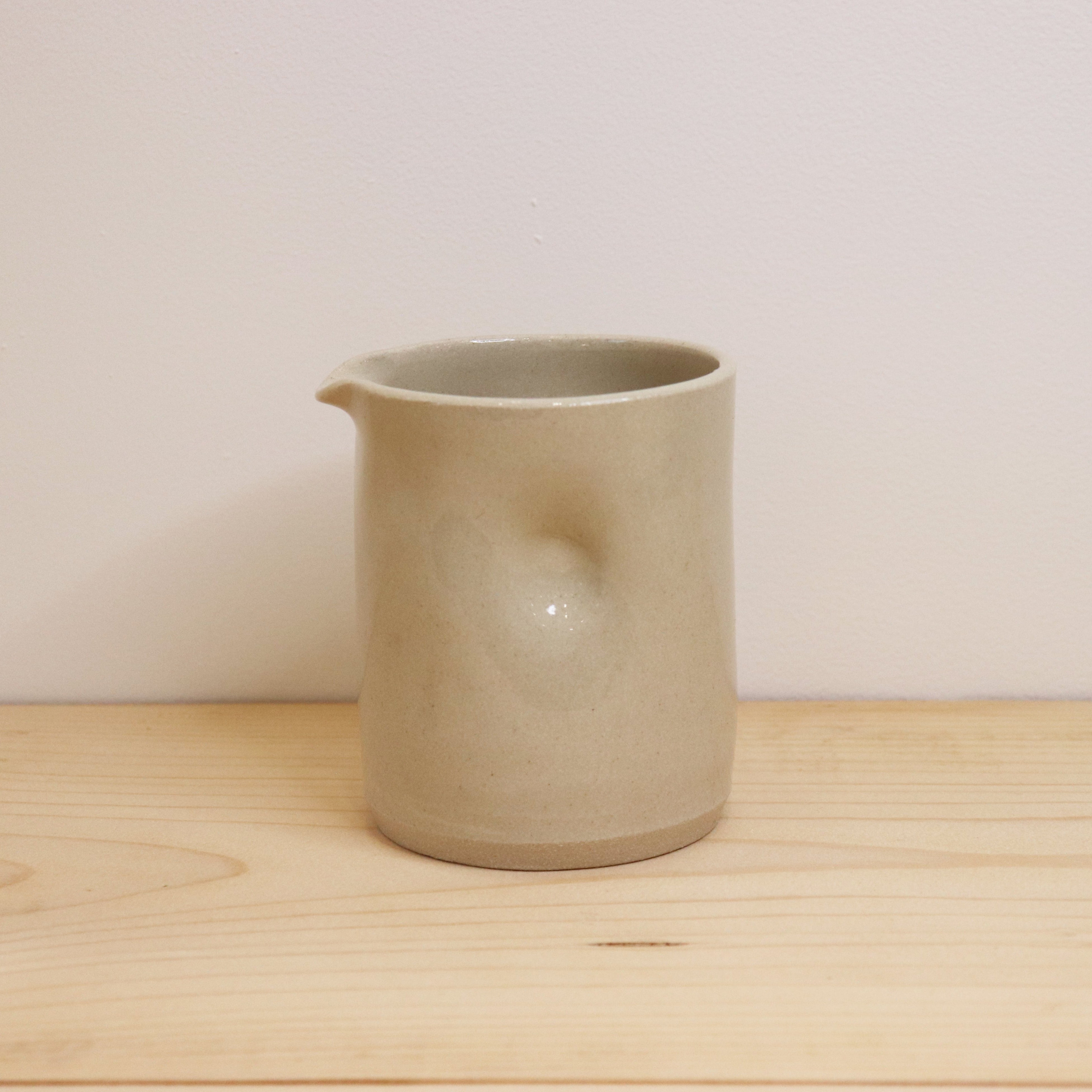 A picture of a single Barton Croft small dimpled jug on a shelf with white background